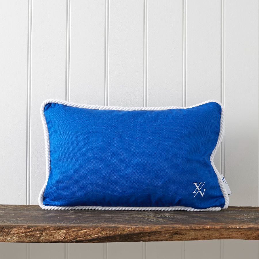 A blue pillow on a wood table Description automatically generated