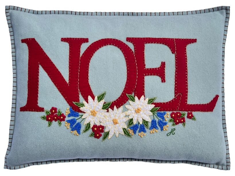 A blue pillow with red letters and flowers

Description automatically generated