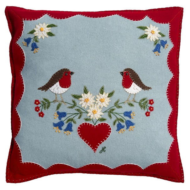 A pillow with birds and flowers

Description automatically generated