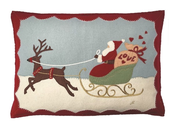 A pillow with santa on a sleigh

Description automatically generated