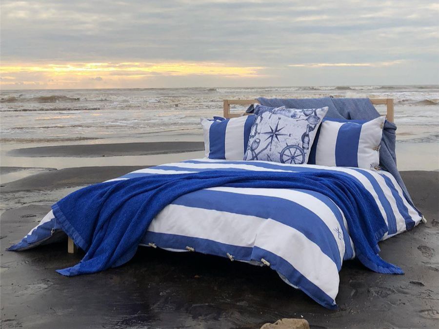 Coastal themed bedding photographed by the sea
