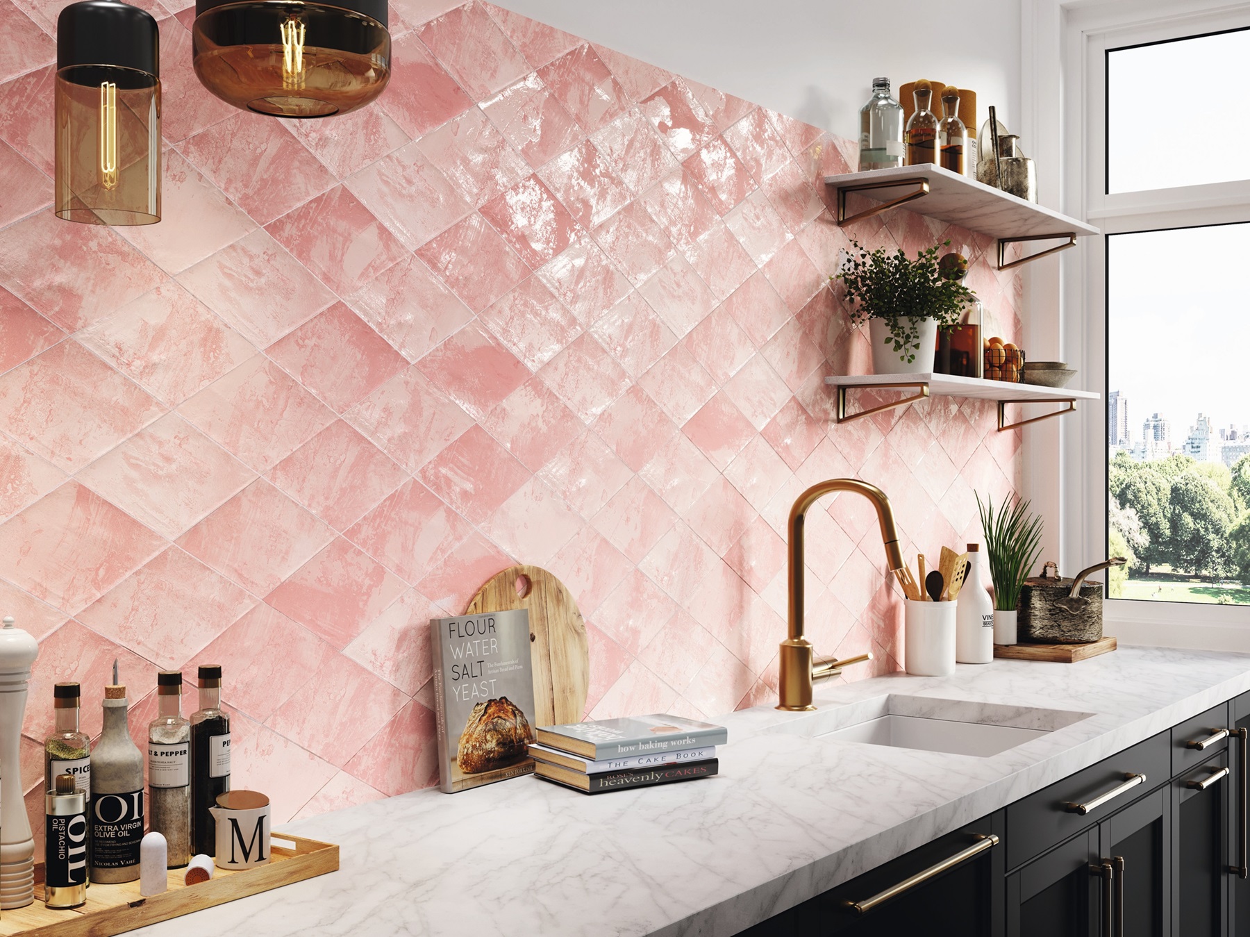 pink tiles on a kitchen wall. There are bottles on the countertop and a sink with modern brass taps.